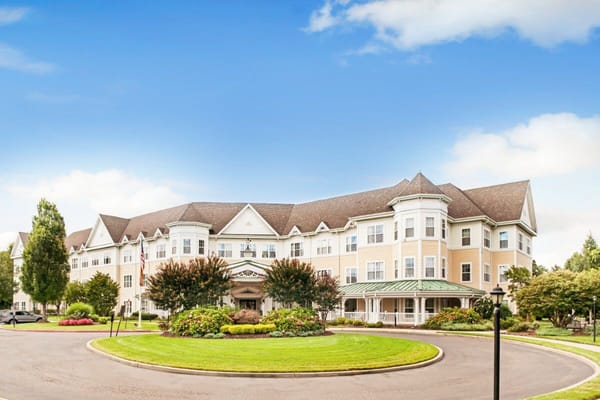 Front entrance of Sunrise of East Meadow senior living facility