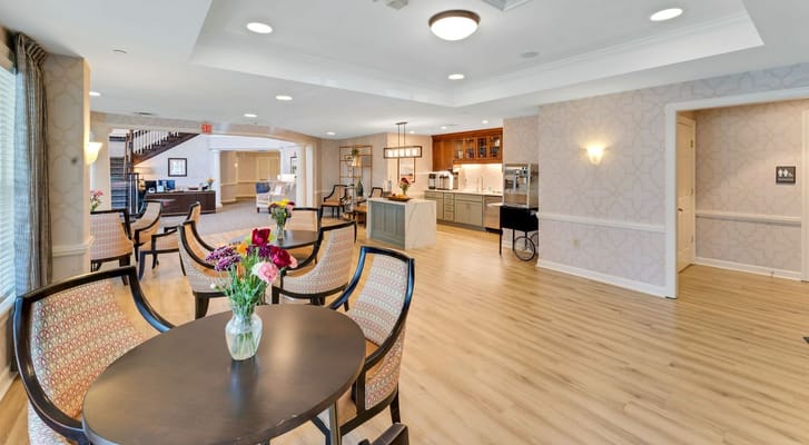 Bright and inviting common area with seating and a kitchen.