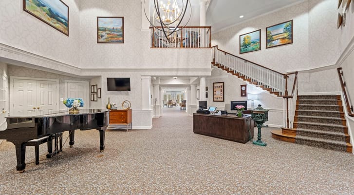 Well-decorated lobby with stairs and piano