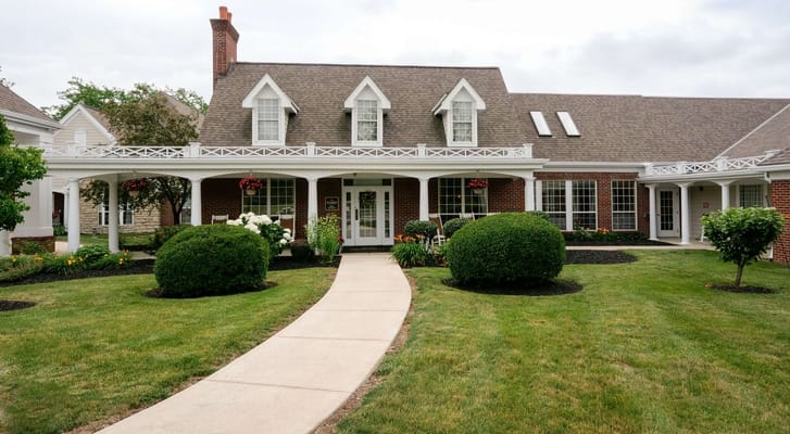 Exterior view of a senior living facility with landscaped garden