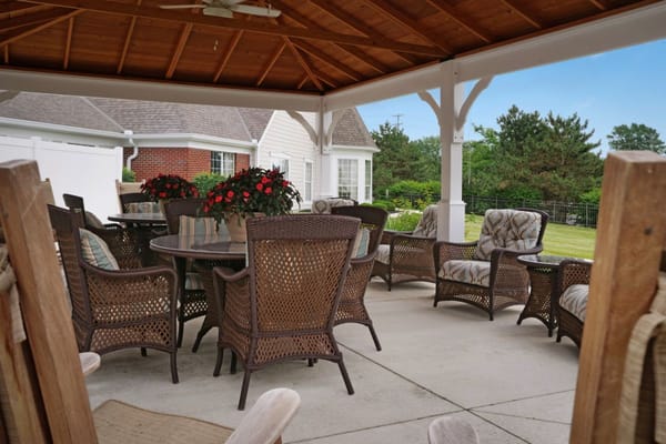 Outdoor seating area with tables and chairs under a gazebo
