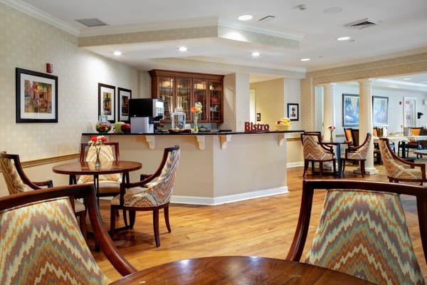 Cozy bistro area with tables and chairs in senior living facility