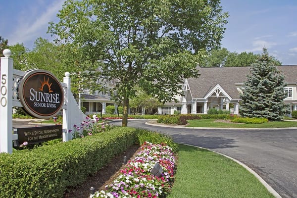 Exterior view of a senior living facility with landscaping