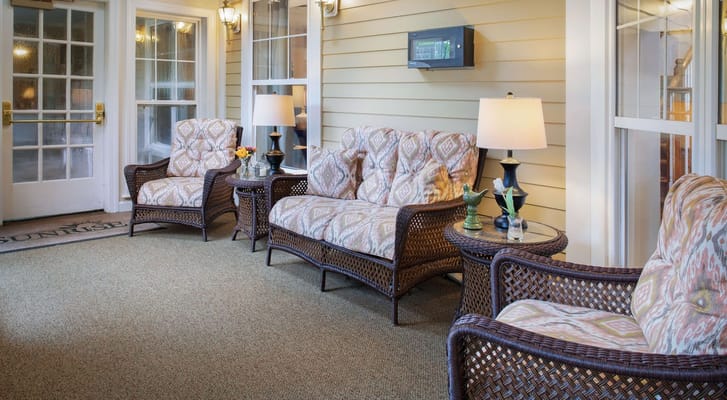 Comfortable wicker seating with cushions on a porch