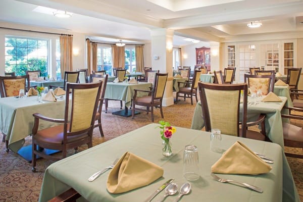 Elegant dining room with tables set for meals
