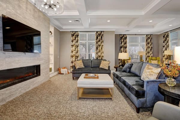 Comfortable living room area with plush seating and decorative curtains