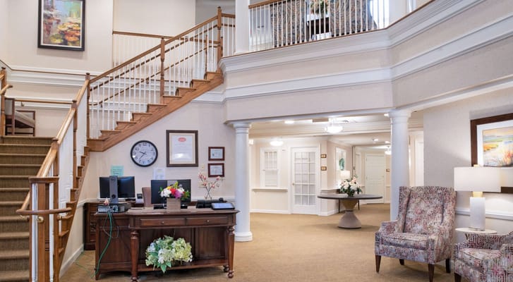 Interior lobby area with staircase and reception desk
