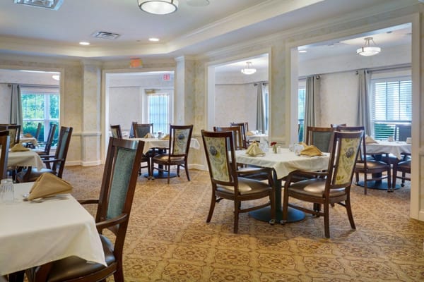 Interior view of the dining room with tables set for dining.