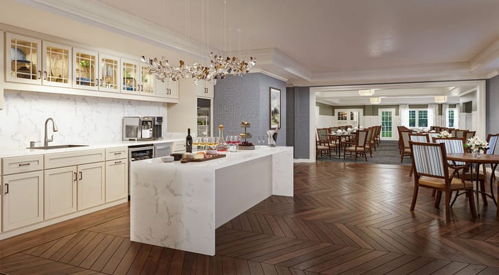 Modern kitchen with dining area at Sunrise of McLean senior living facility.