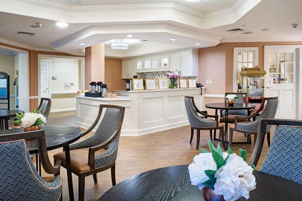 Cozy common area with seating and a refreshment station