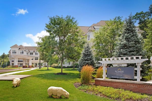 Exterior view of Sunrise of North Wales with greenery and entrance.