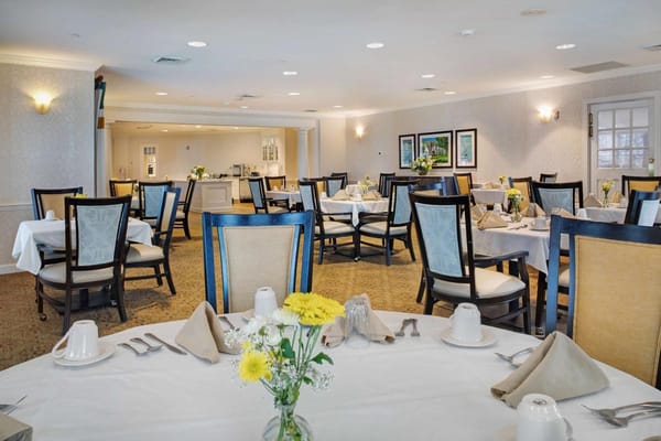 Spacious dining area with set tables and floral centerpieces