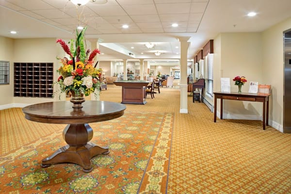 Brightly decorated lobby with floral arrangement and reception area