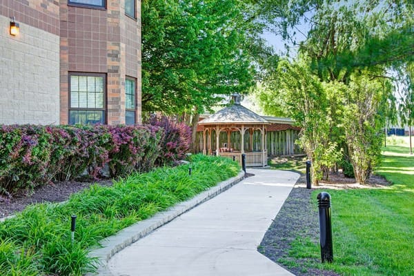 Pathway leading to gazebo surrounded by greenery at Sunrise of Park Ridge