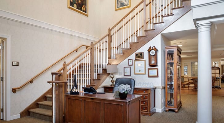 Reception area with a wooden desk and staircase
