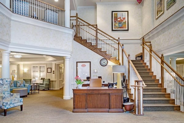 Bright lobby area with a staircase and reception desk