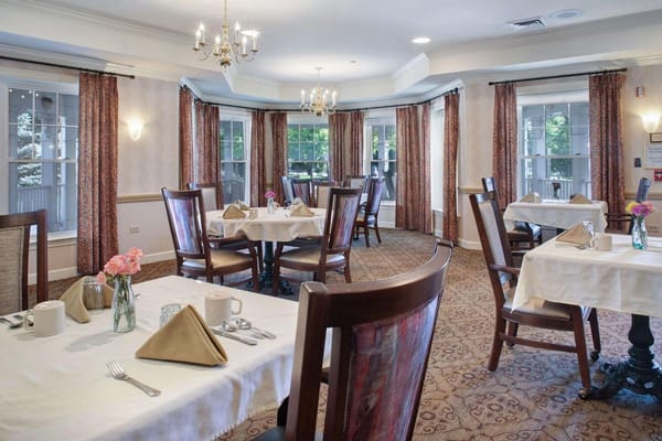 Dining room setup with tables and chairs