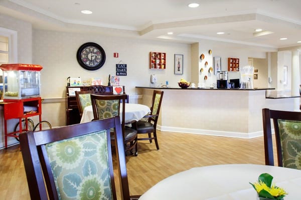 Bright common area with tables and popcorn machine