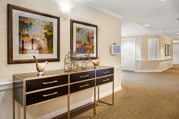 Decorative hallway with art pieces and a console table.