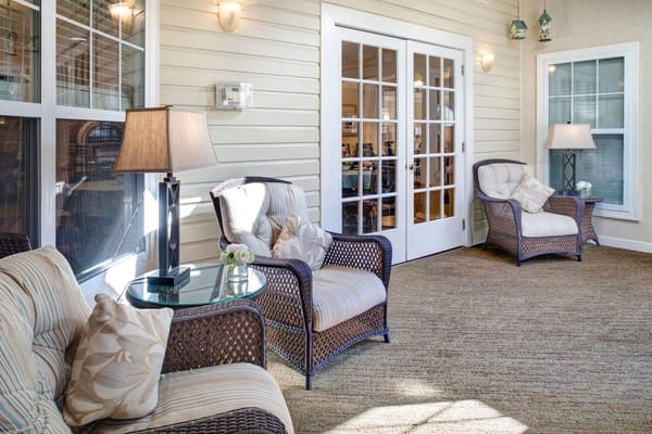 Cozy lounge area with wicker chairs and a glass table
