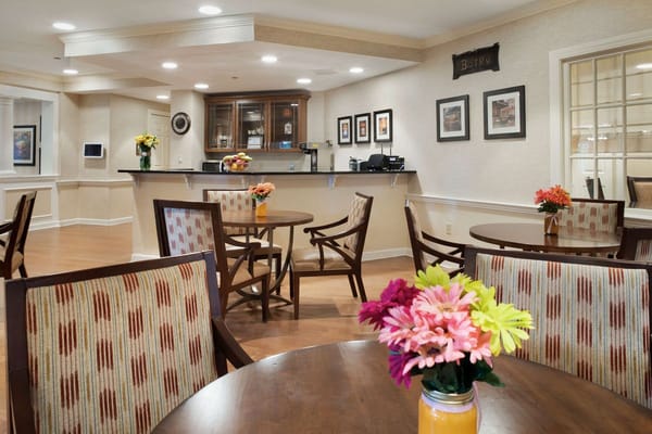 Interior view of the bistro with tables and floral centerpieces.