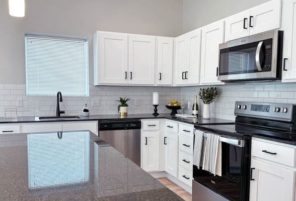 Stylish kitchen with white cabinets and modern appliances