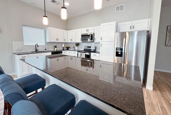 Spacious kitchen with granite countertops and stainless steel appliances