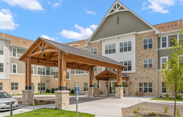 Main entrance with a wooden canopy at Talamore Senior Living in Woodbury