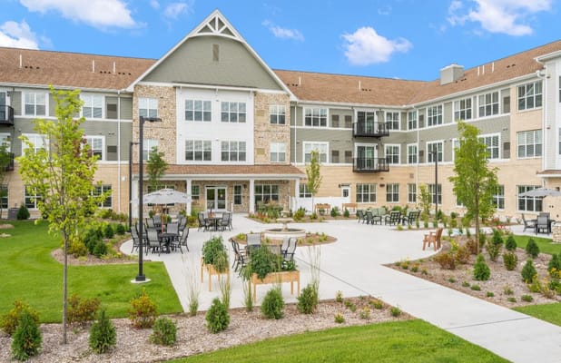 Outdoor courtyard with seating areas at Talamore Senior Living Woodbury