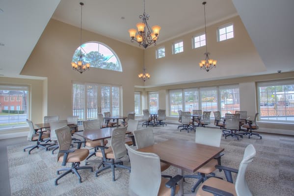 Bright common area with tables and chairs in Tapestry House