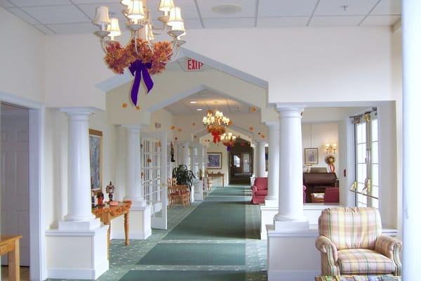 Bright and spacious hallway with chandeliers and decorative elements