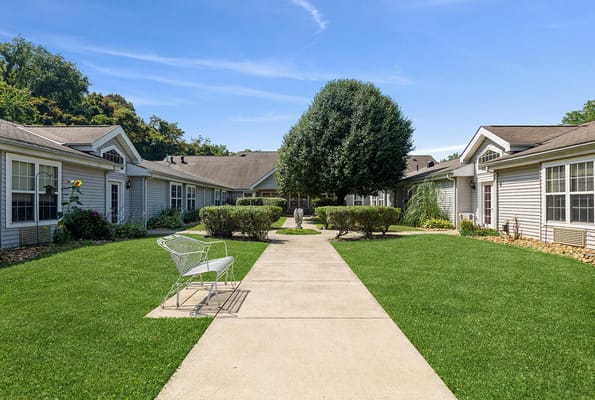 Pathway through the courtyard with lush greenery and benches