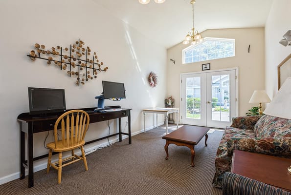Bright living room with computers and natural light