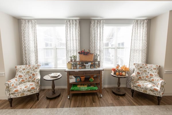 Cozy common area with floral chairs and natural light