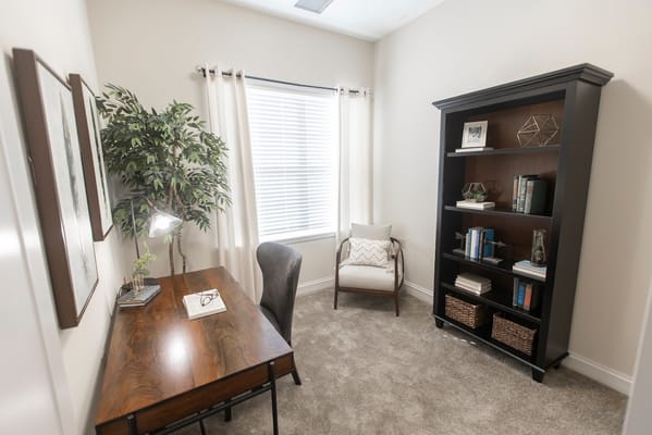 A cozy private resident room with desk and bookshelf