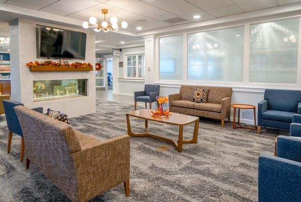 Lounge area with seating and a fireplace in The Branches of Framingham