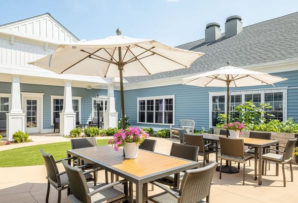 Sunlit outdoor patio with tables and umbrellas at The Branches of Marlboro.