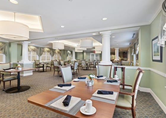 Spacious dining room with tables set for meals