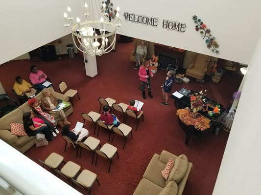 Residents and children interacting in a welcoming common area