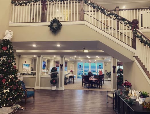 Lobby area decorated for the holidays with a Christmas tree and dining setup.