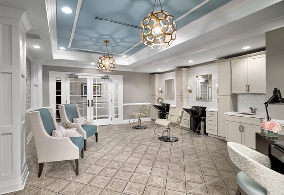 Modern salon space with seating and hair styling stations