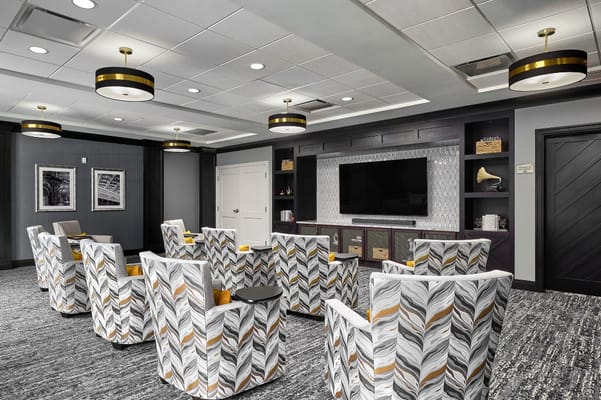 Modern lounge with patterned chairs and a television