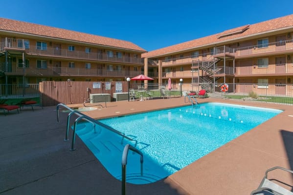 Swimming pool surrounded by loungers at The Citadel Senior Living Community.