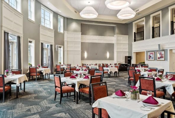 Elegant dining room with tables set for meals.