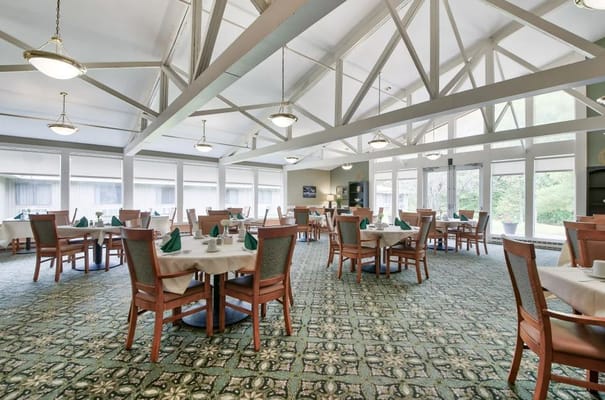 Dining room with tables set and green napkins