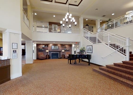 Interior view of the lobby featuring a piano and seating areas.