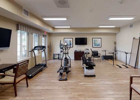 Fitness room with exercise equipment and seating