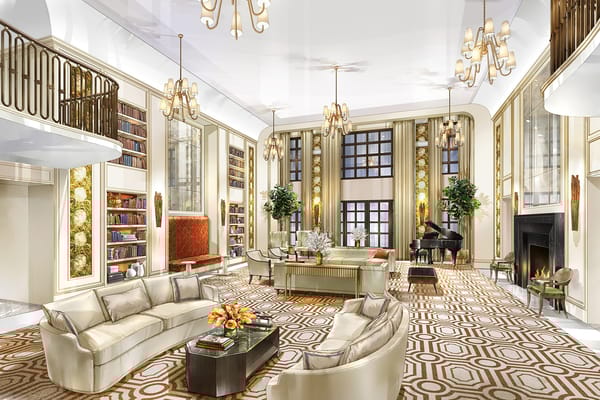 Elegant living room with a grand piano, bookshelves, and comfortable seating.