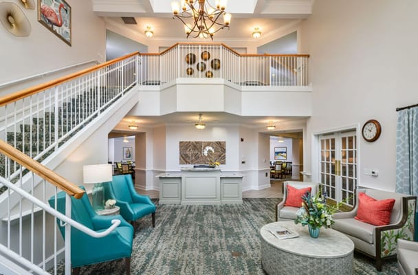 Bright and spacious lobby with seating and a staircase