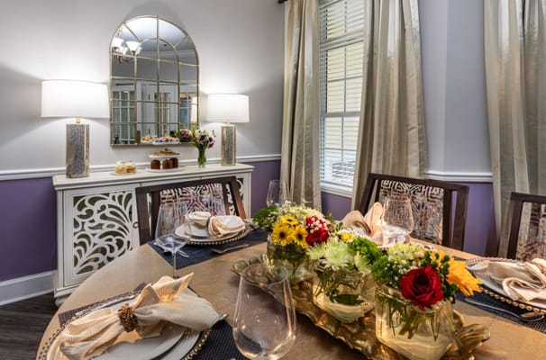 Dining table set with flowers and elegant tableware.